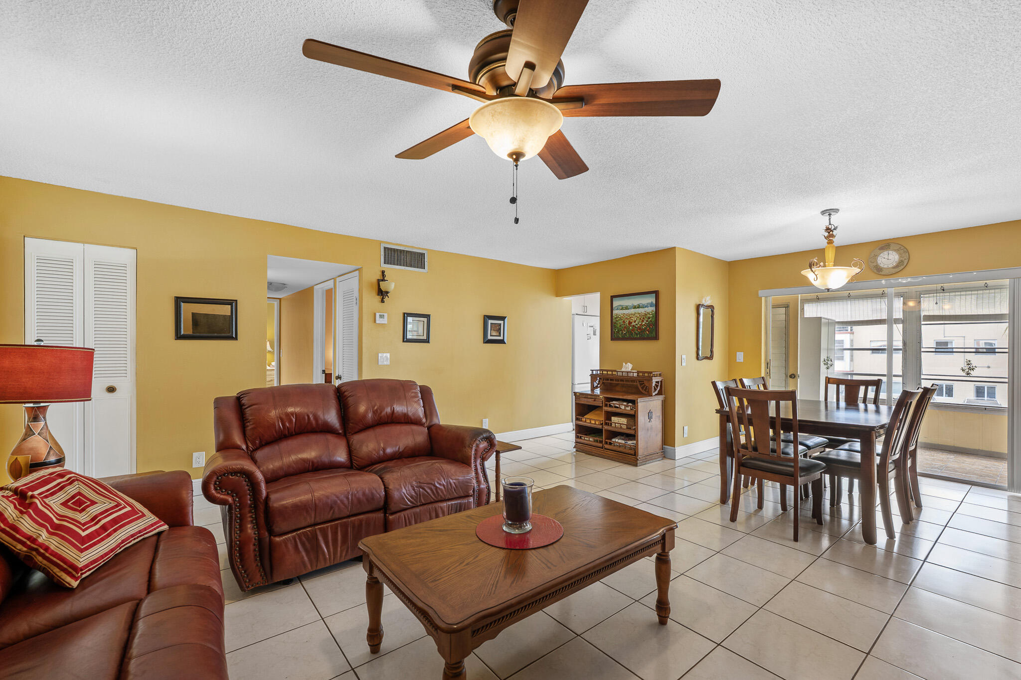 4047 Northwest 16th Street, Unit 206 Lauderhill, FL 33313 - Photo 8 of 26 a living room with furniture a table and a chandelier