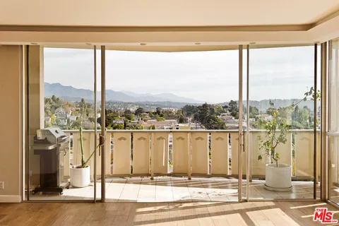 a view of a city from a floor to ceiling window
