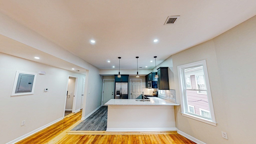 109 Deering Road, Unit 1 Boston, MA 02126 - Photo 2 of 12 a view of kitchen with stainless steel appliances kitchen island sink stove and refrigerator