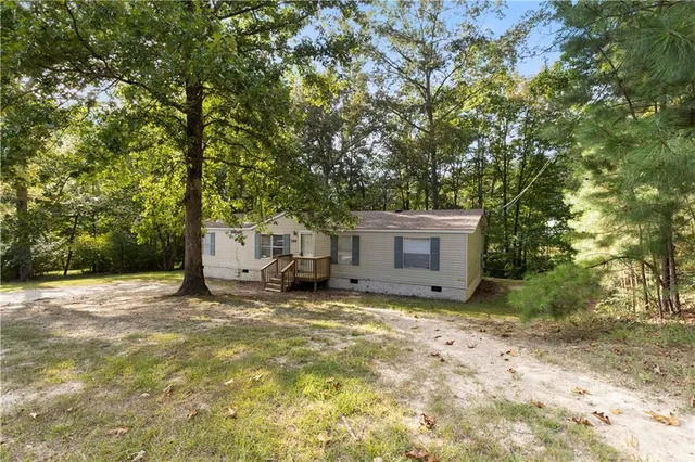 a view of a house with large trees and a large tree