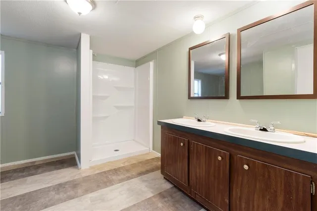 a bathroom with a sink vanity and mirror
