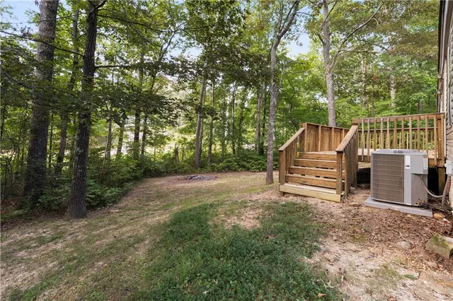 a view of backyard with deck and trees