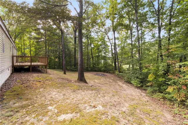 a view of a house with a yard and deck