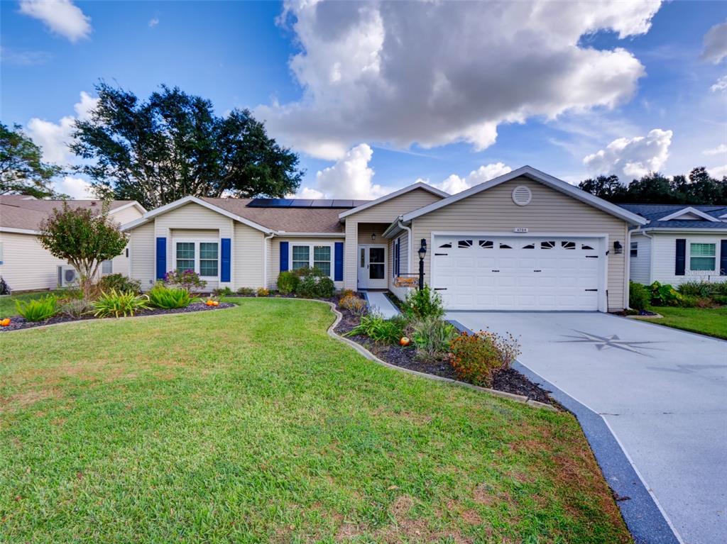 4704 River Ridge Drive Leesburg, FL 34748 - Photo 1 of 40 a front view of a house with garden