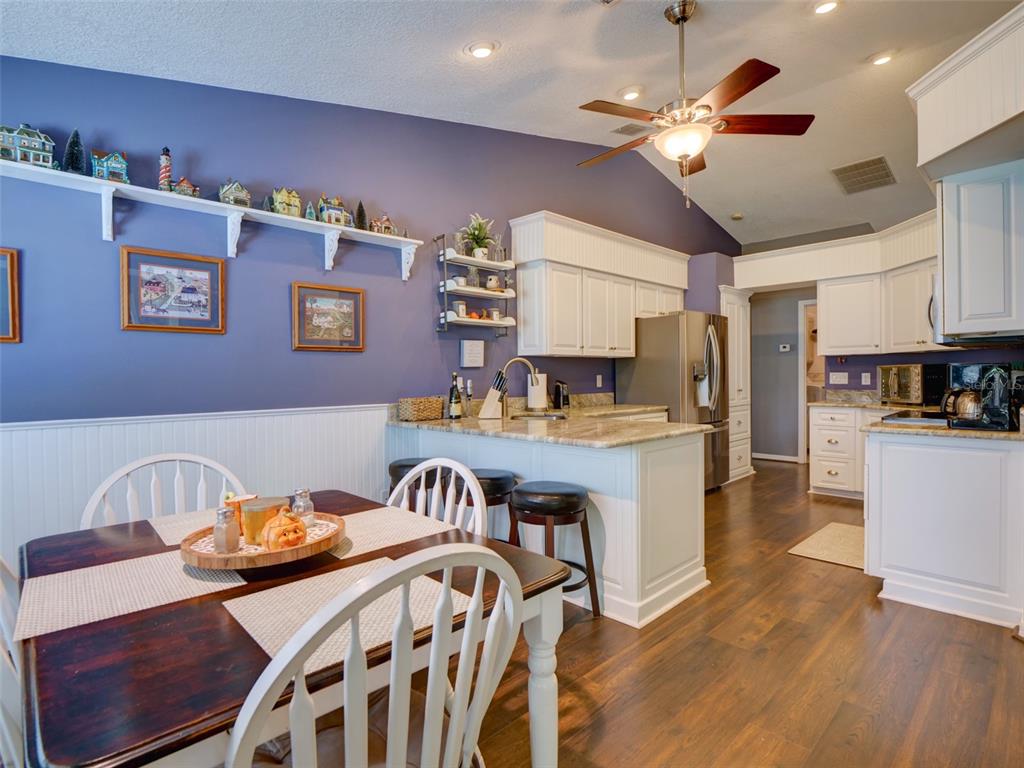 4704 River Ridge Drive Leesburg, FL 34748 - Photo 15 of 40 a view of a dining room with furniture and wooden floor