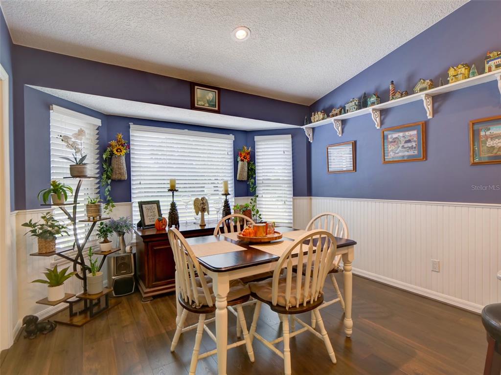 4704 River Ridge Drive Leesburg, FL 34748 - Photo 16 of 40 a dining room with furniture and wooden floor