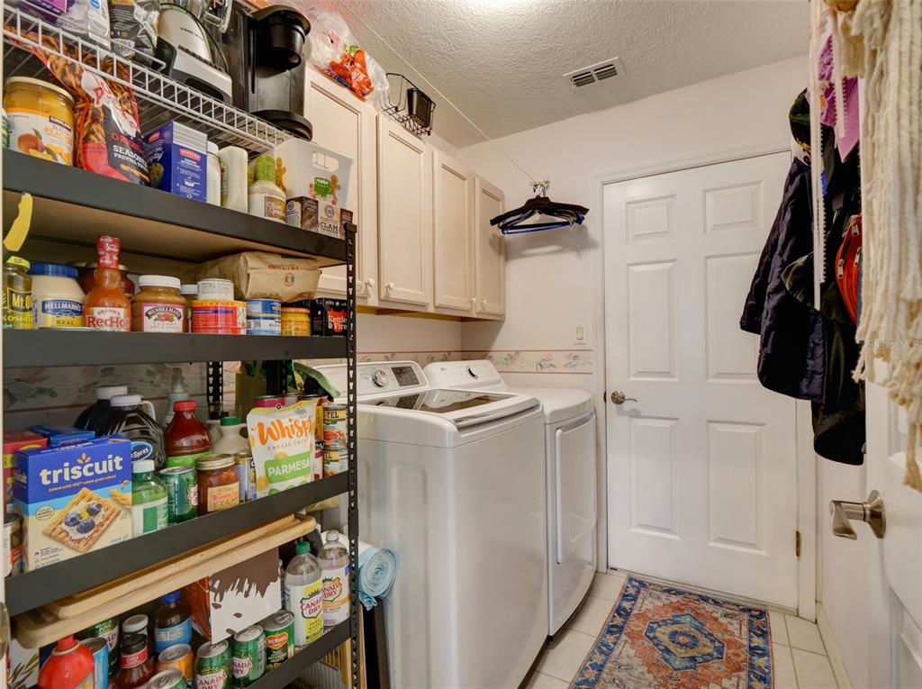 4704 River Ridge Drive Leesburg, FL 34748 - Photo 26 of 40 a view of walk in closet with clothes and shoes