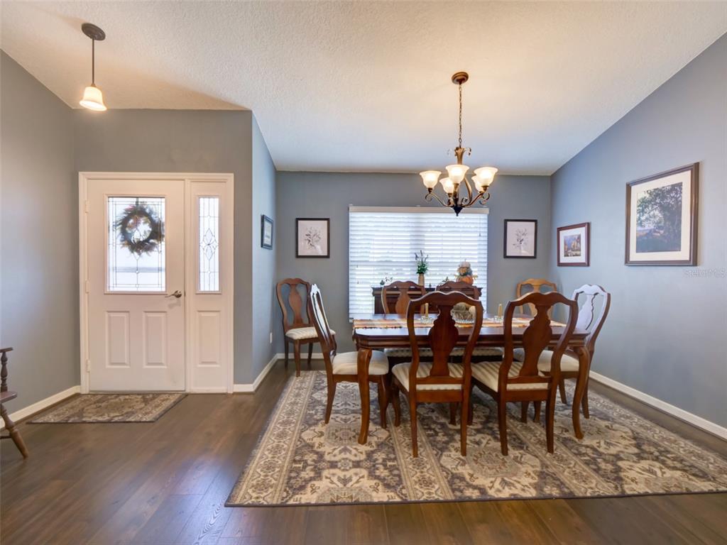 4704 River Ridge Drive Leesburg, FL 34748 - Photo 5 of 40 a view of a dining room with furniture window and wooden floor