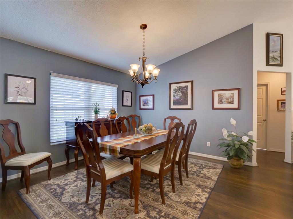 4704 River Ridge Drive Leesburg, FL 34748 - Photo 6 of 40 a view of a dining room with furniture window and wooden floor