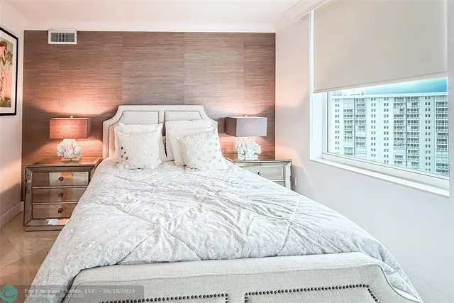 a bedroom with a bed and a night stand