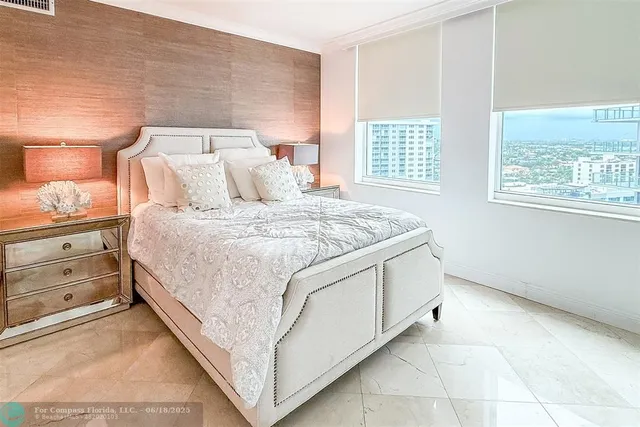 a spacious bedroom with a bed and a window