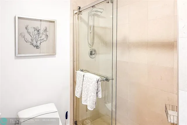 a bathroom with a shower and a toilet