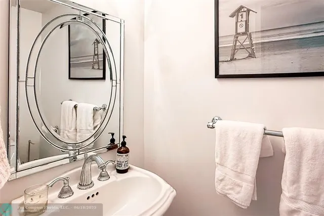 a bathroom with a sink mirror and vanity