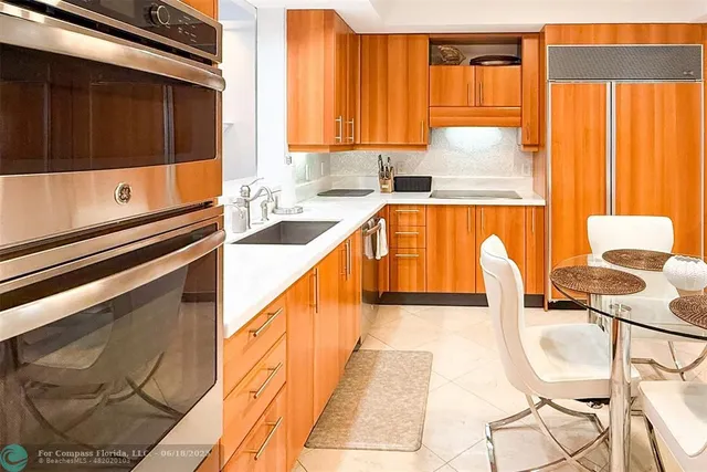 a kitchen with stainless steel appliances a sink a stove and a microwave