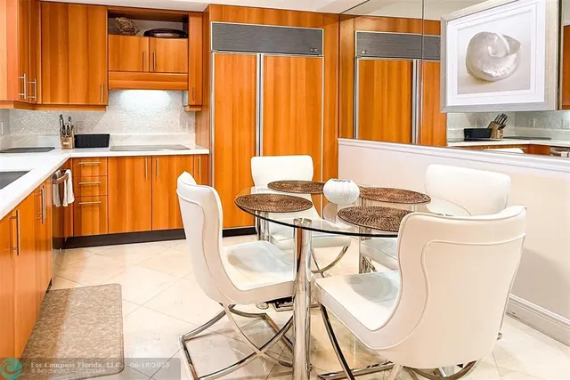 a kitchen with a table chairs and a window