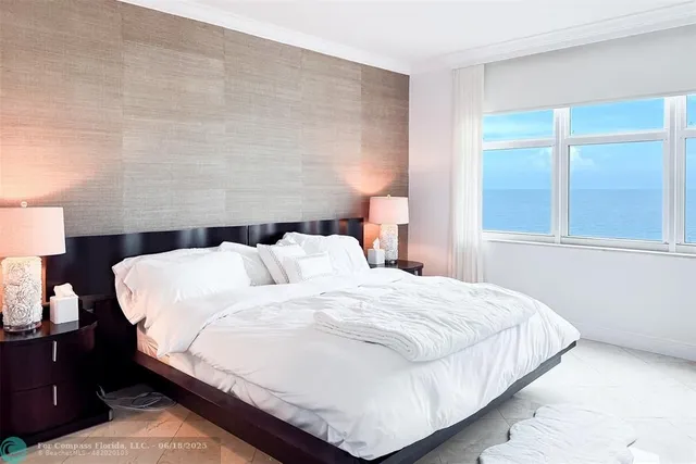 a large bed sitting in a bedroom next to a window