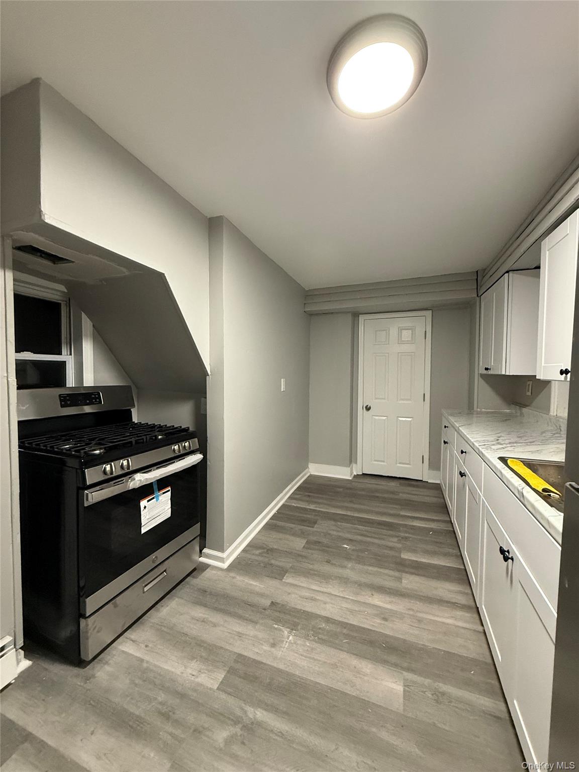 7 Grant Street, Unit 1 Poughkeepsie, NY 12601 - Photo 1 of 9 a kitchen with stove cabinets and stainless steel appliances