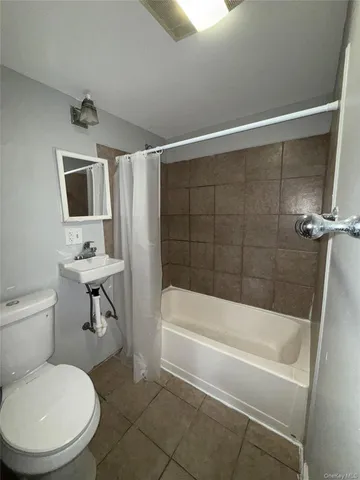 a bathroom with a toilet a sink and bathtub