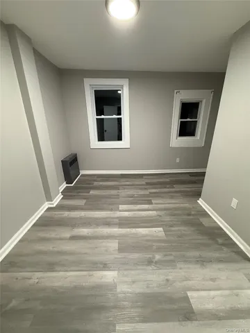 a view of a livingroom with wooden floor and window
