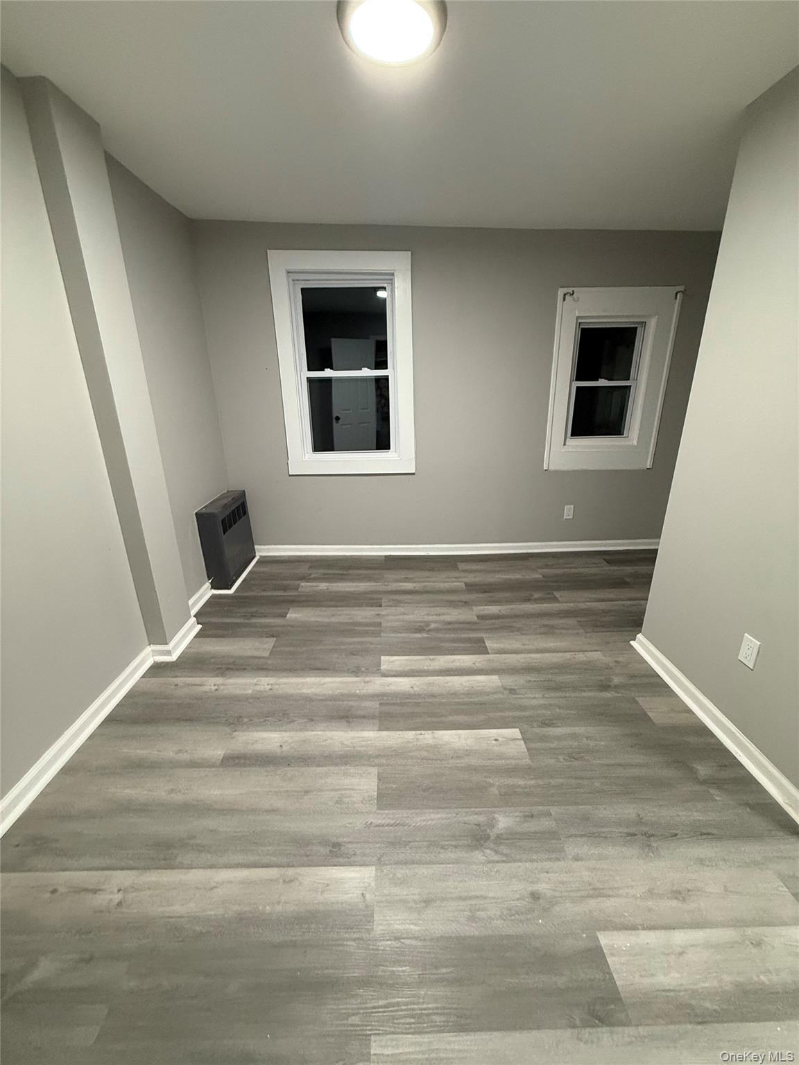 7 Grant Street, Unit 1 Poughkeepsie, NY 12601 - Photo 8 of 9 a view of a livingroom with wooden floor and window