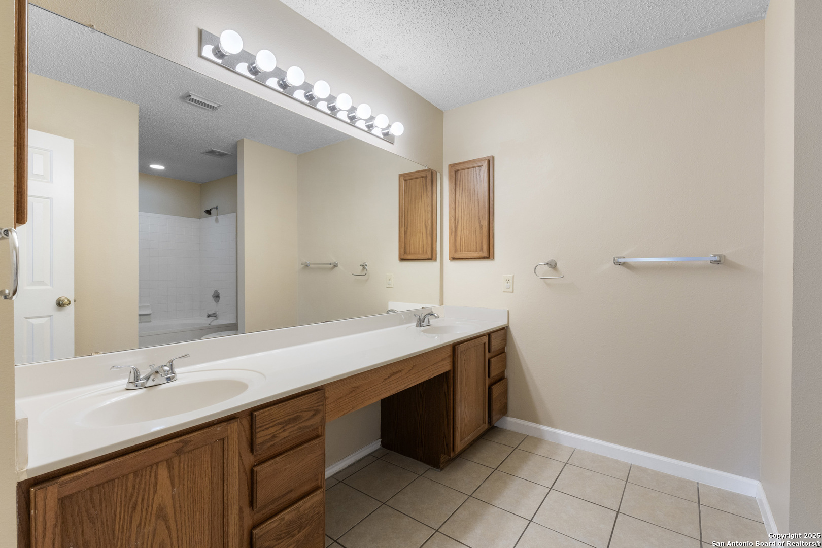 1555 Jasmine Schertz, TX 78154 - Photo 15 of 23 a bathroom with a double vanity sink and a mirror