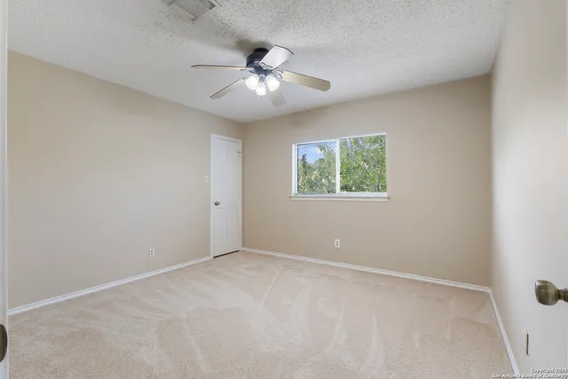 a view of an empty room with a fan