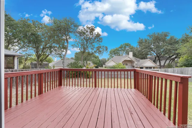 a view of a balcony with wooden fence