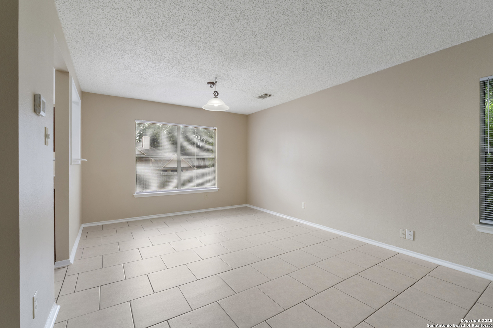 1555 Jasmine Schertz, TX 78154 - Photo 7 of 23 a view of an empty room with a window