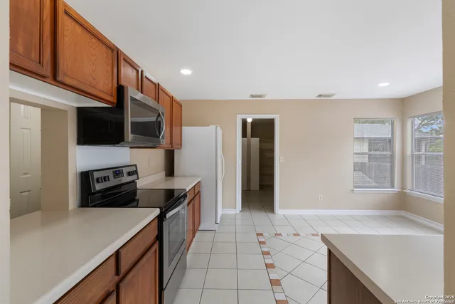a kitchen with a sink a stove and refrigerator
