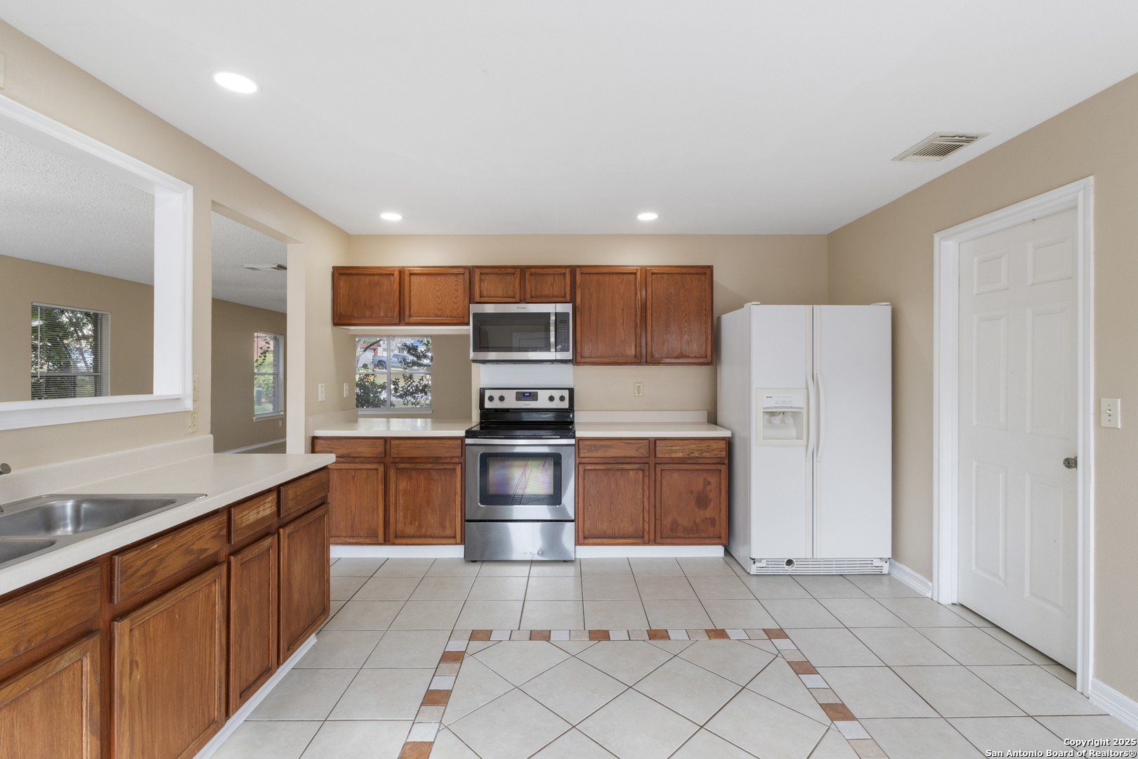 1555 Jasmine Schertz, TX 78154 - Photo 10 of 23 a large kitchen with stainless steel appliances kitchen island granite countertop a refrigerator and a sink