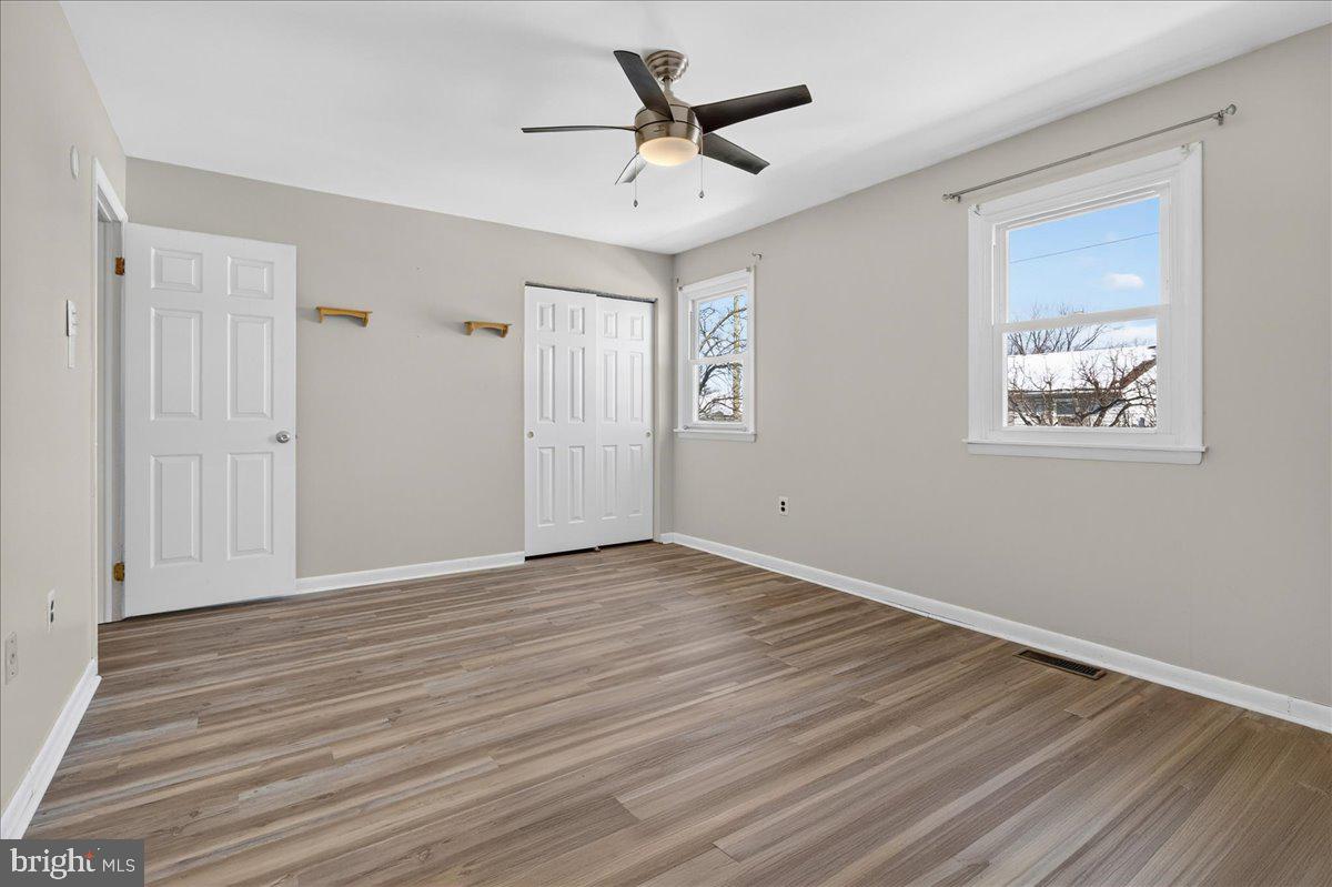 1158 Grove Street Pottstown, PA 19464 - Photo 16 of 26 an empty room with wooden floor and ceiling fan