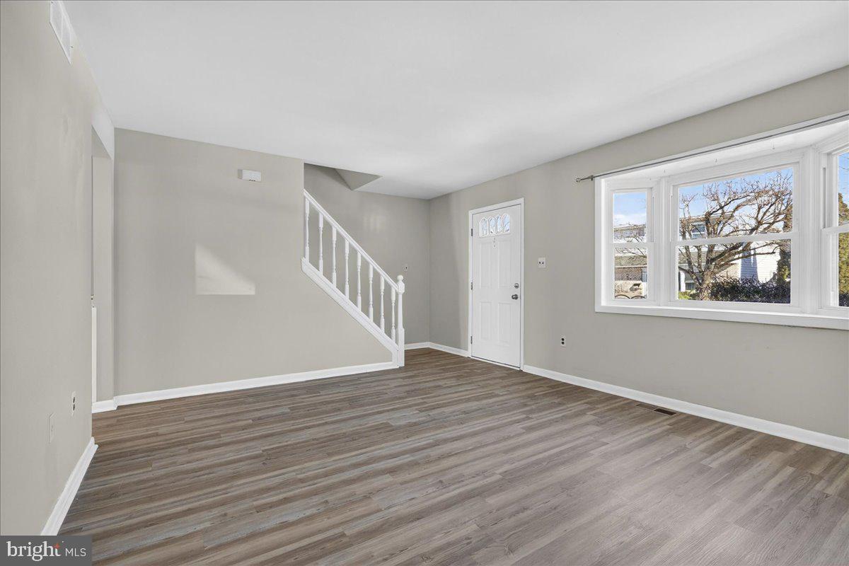 1158 Grove Street Pottstown, PA 19464 - Photo 4 of 26 a view of an empty room with wooden floor and a window