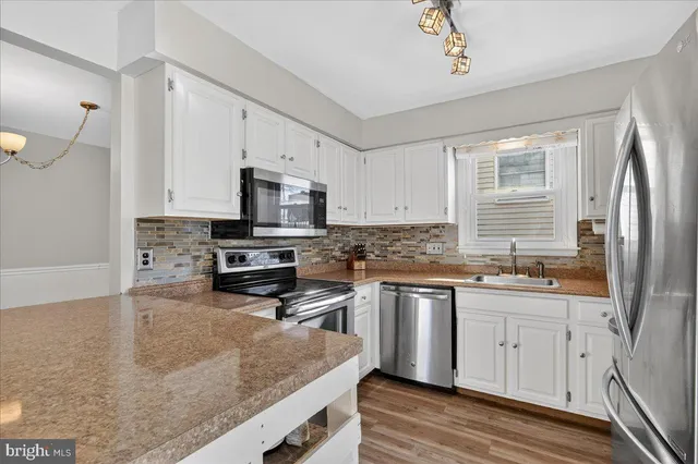 a toilet sitting next to a white wall