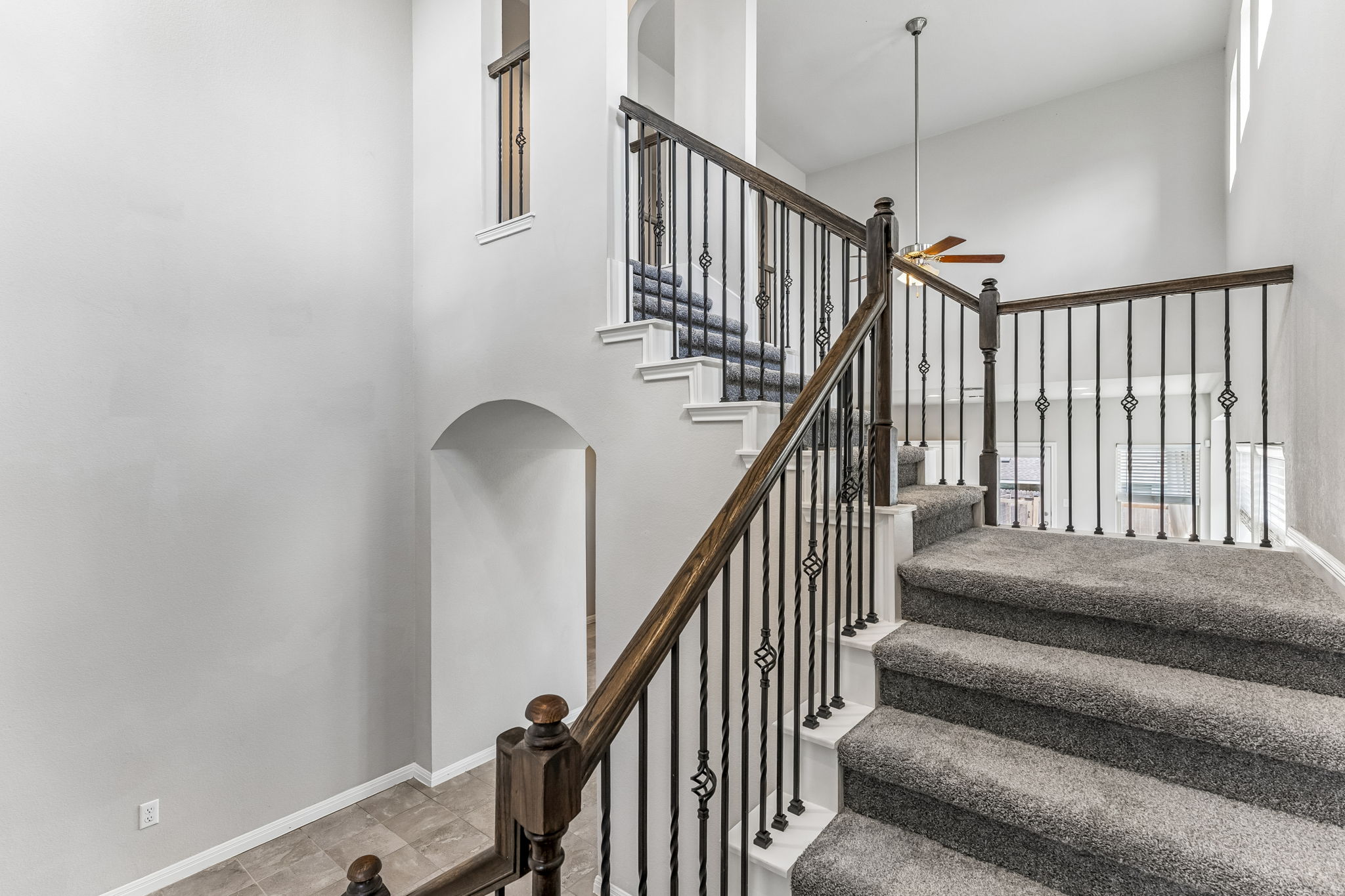 689 Nautical Loop Kyle, TX 78640 - Photo 20 of 34 Elegant iron balusters complement the sweeping staircase leading to an airy upper landing.