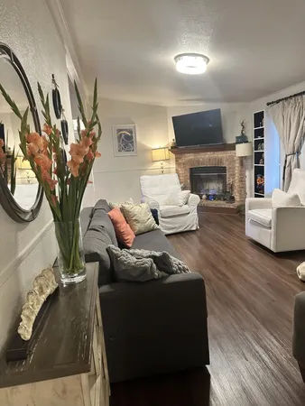 a living room with furniture a fireplace and a flat screen tv