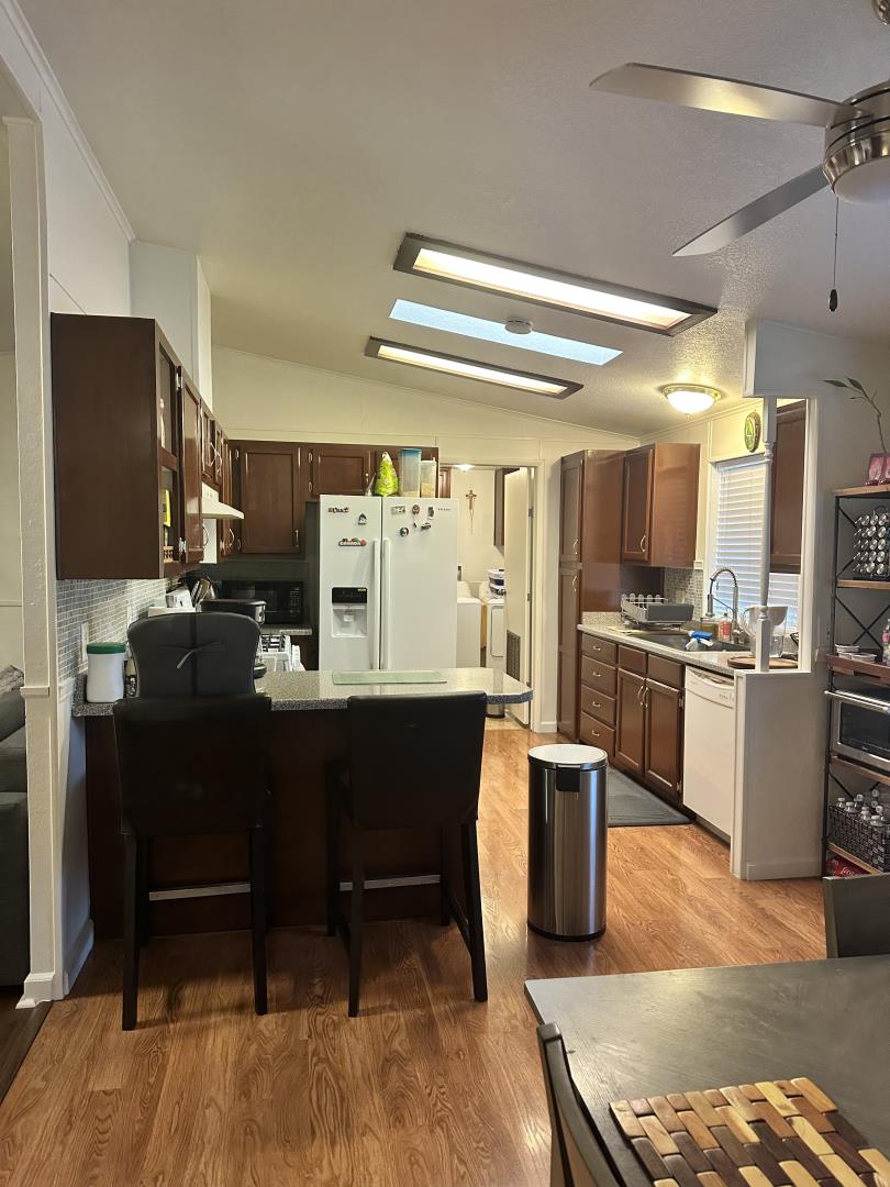6130 Monterey Road, Unit 9 San Jose, CA 95138 - Photo 14 of 27 a kitchen with a sink stainless steel appliances and cabinets