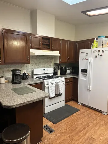 a kitchen with a sink a stove and refrigerator
