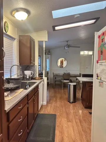 a kitchen with a sink appliances and cabinets