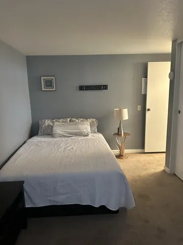 a bedroom with a bed and window