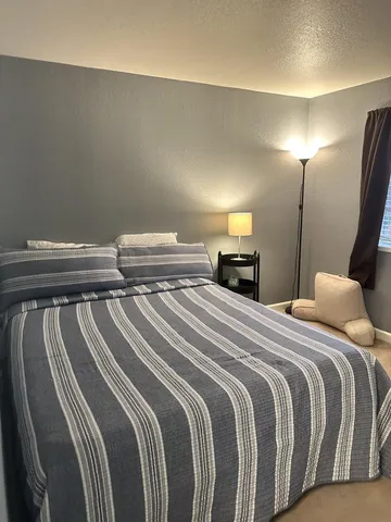 a bedroom with a bed and a mirror