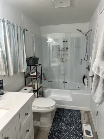 a bathroom with a sink toilet and shower