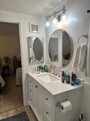a bathroom with double vanity sink and a mirror
