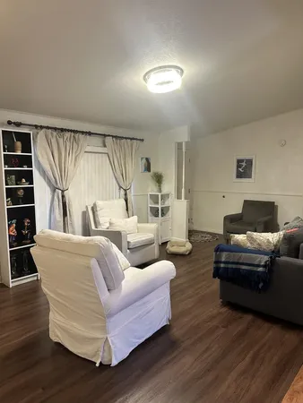 a living room with furniture and a large window