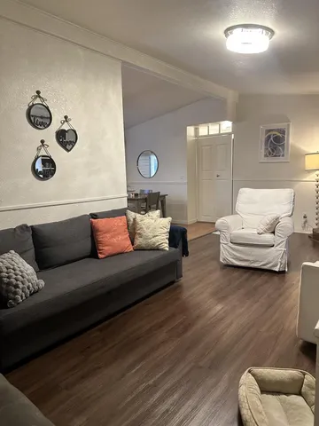 a living room with furniture and white walls