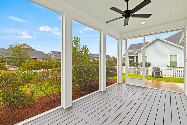a view of a house with a yard and potted plants