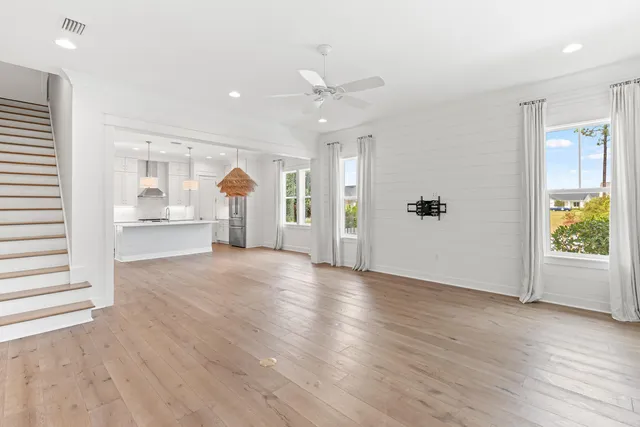 a view of a room with wooden floor and a large window