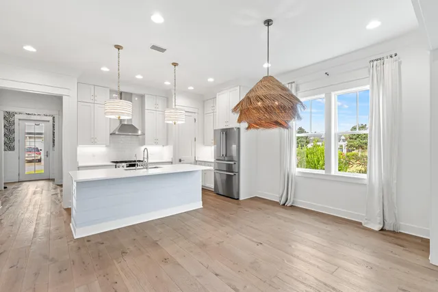 a view of a kitchen with a sink and a chandelier