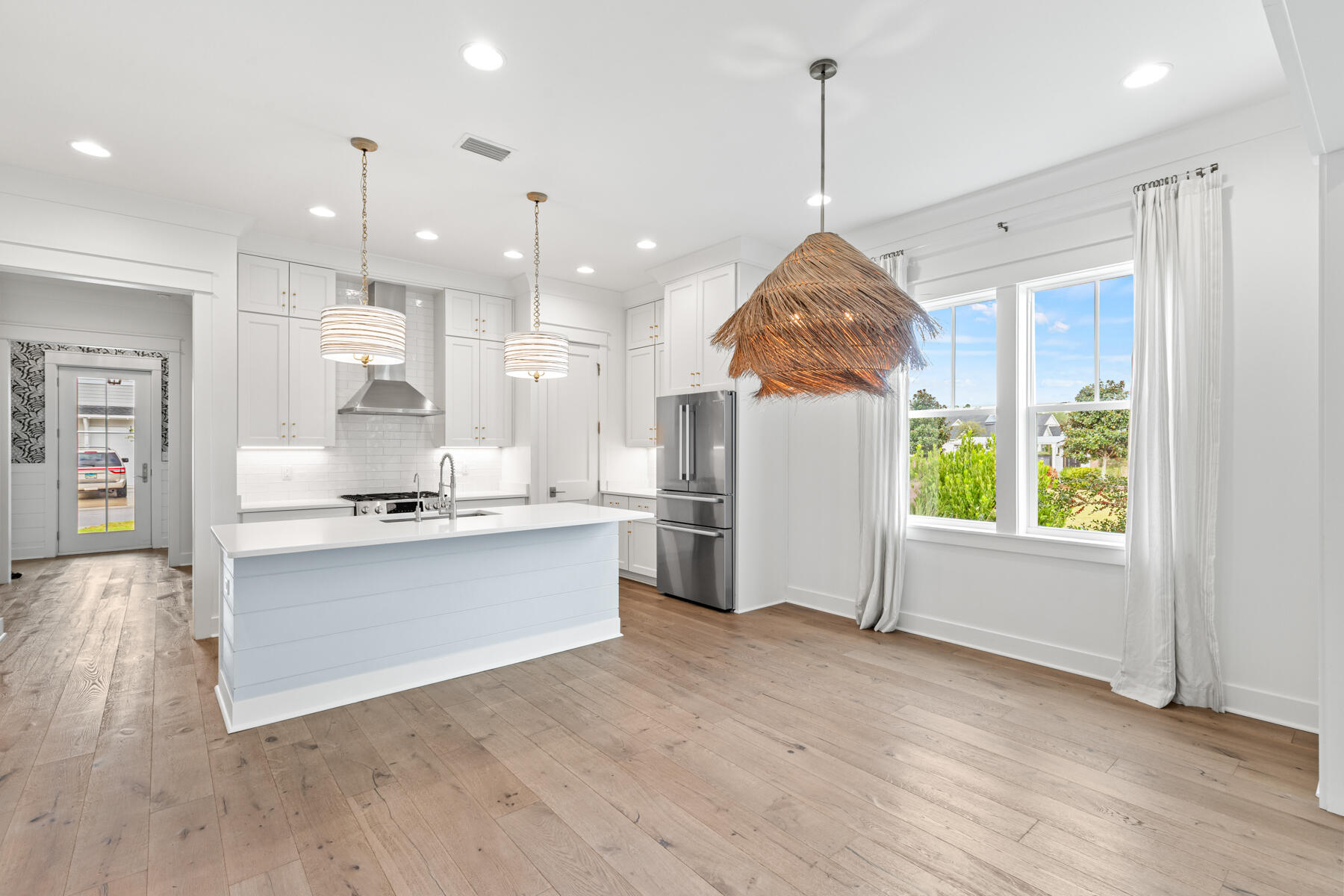 79 Basal St Inlet Beach Inlet Beach, FL 32461 - Photo 23 of 41 a kitchen with stainless steel appliances granite countertop a sink a stove a refrigerator and white cabinets with wooden floor