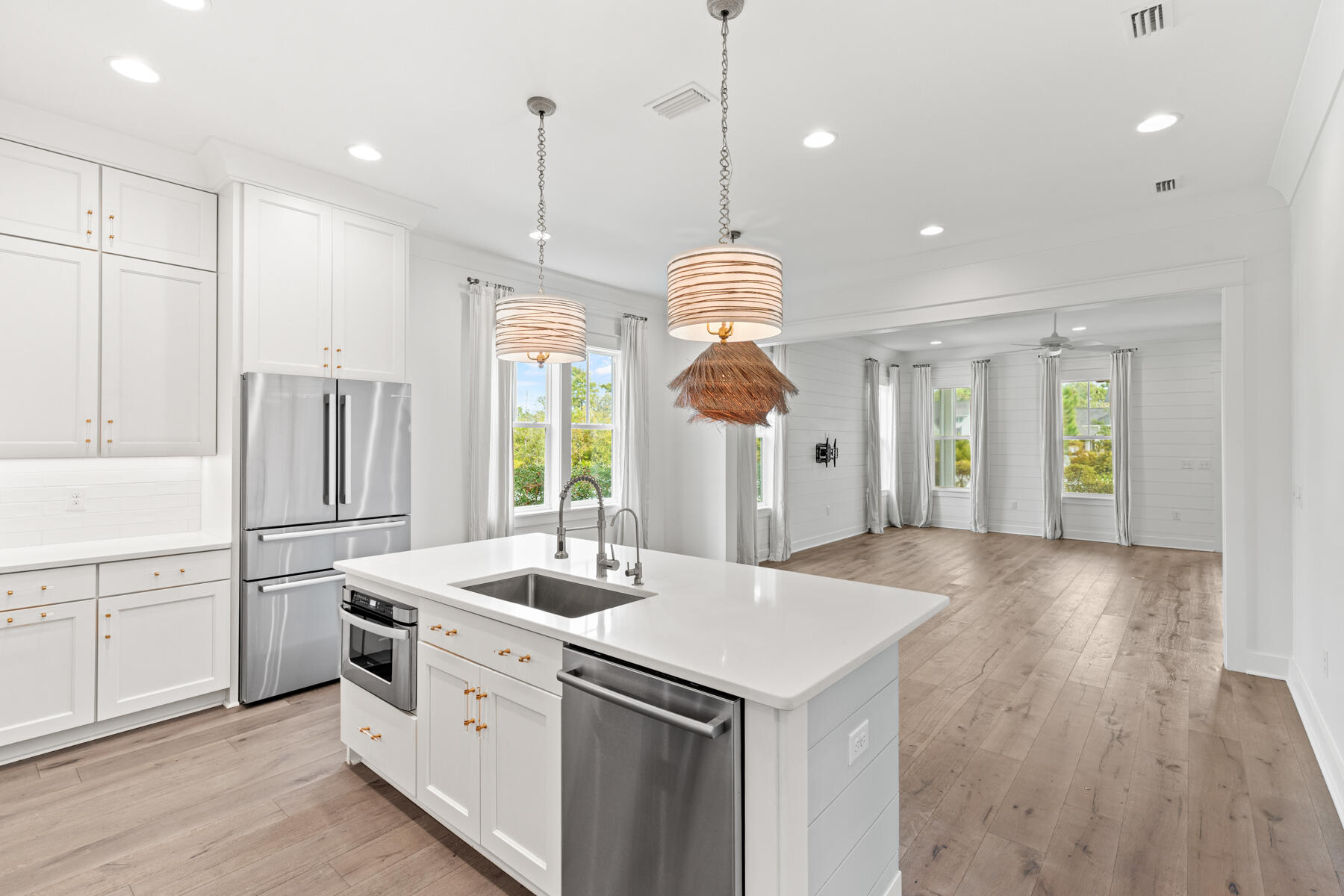 79 Basal St Inlet Beach Inlet Beach, FL 32461 - Photo 25 of 41 a kitchen with stainless steel appliances granite countertop a sink a stove a refrigerator and white cabinets with wooden floor