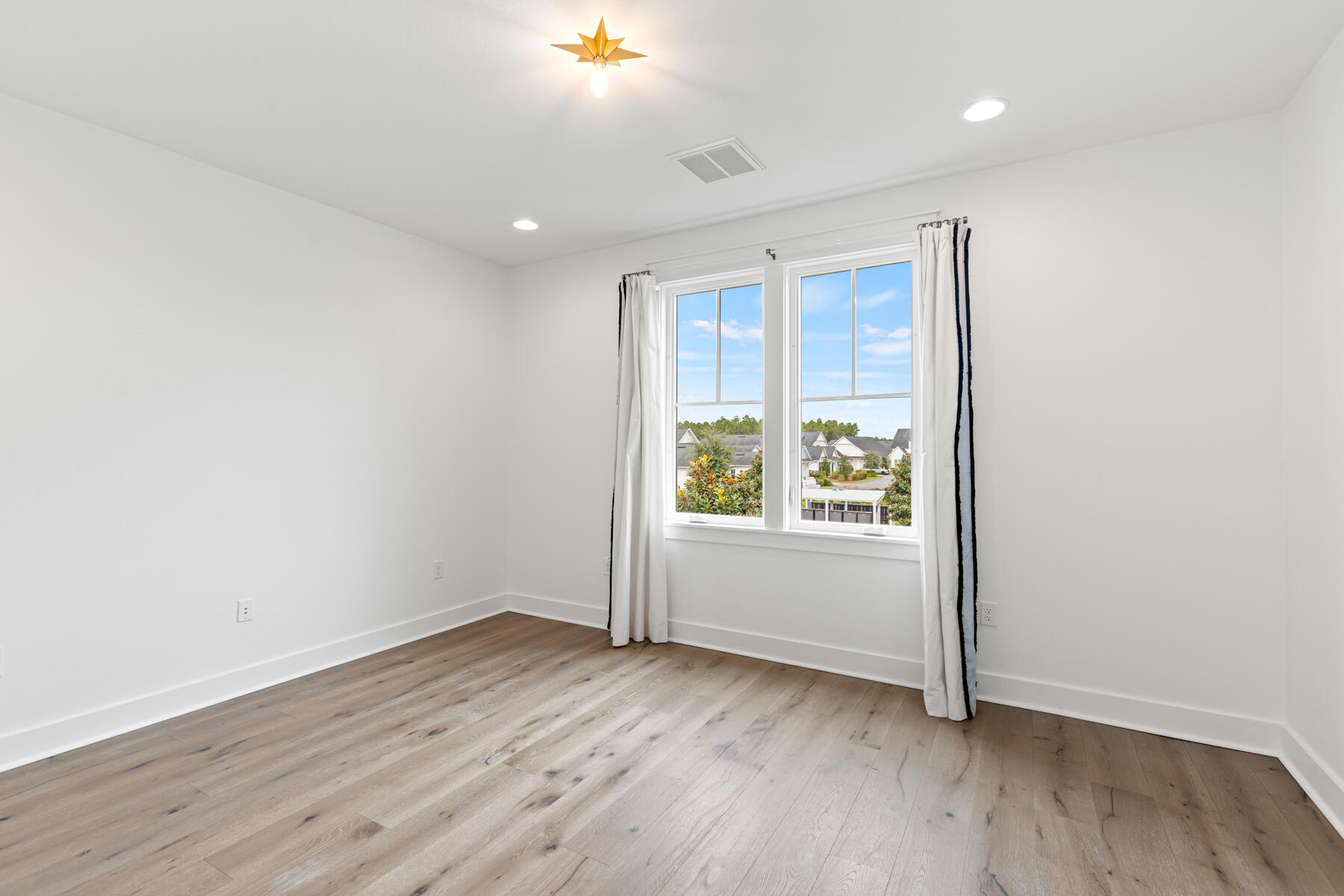 79 Basal St Inlet Beach Inlet Beach, FL 32461 - Photo 32 of 41 an empty room with wooden floor and windows